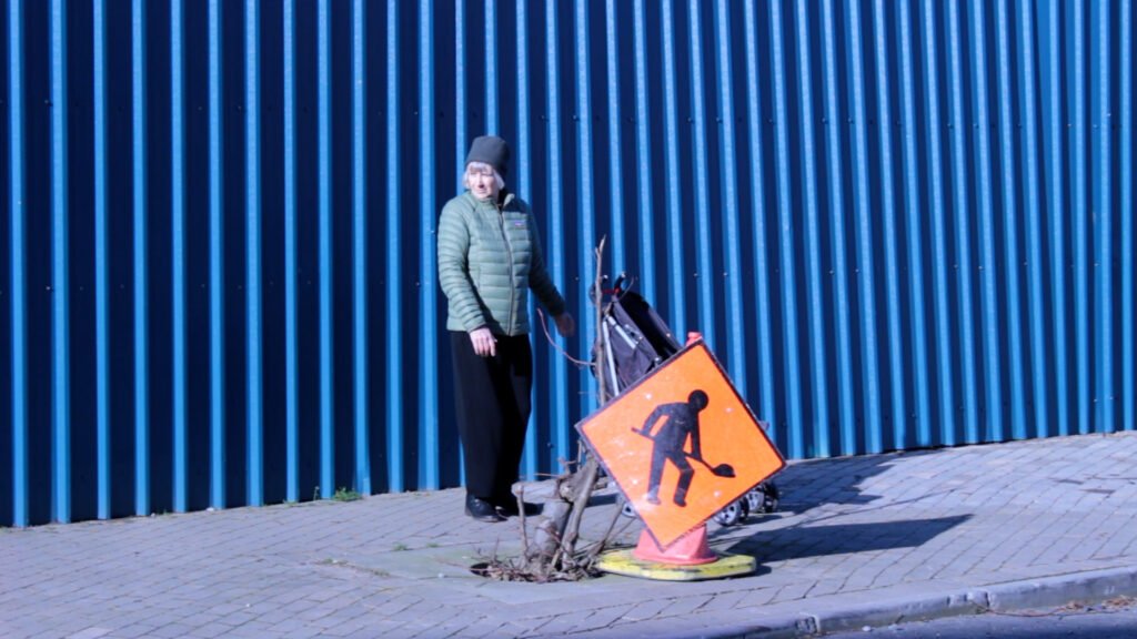 buggy behind orange sign